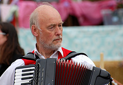 Old man playing his accordion instrument